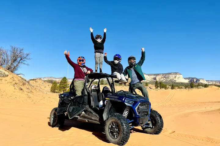 a man riding a motorcycle down a dirt road