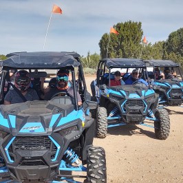 a tractor in a parking lot full of cars