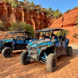 a truck driving down a dirt road